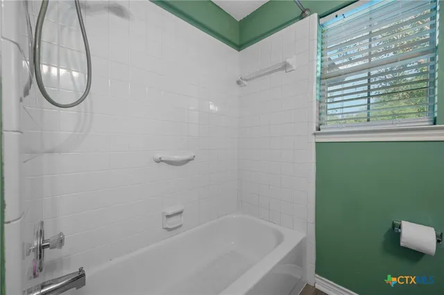 a bathroom with a bath tub and a shower