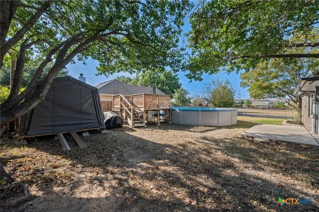 a view of a house with backyard and sitting area