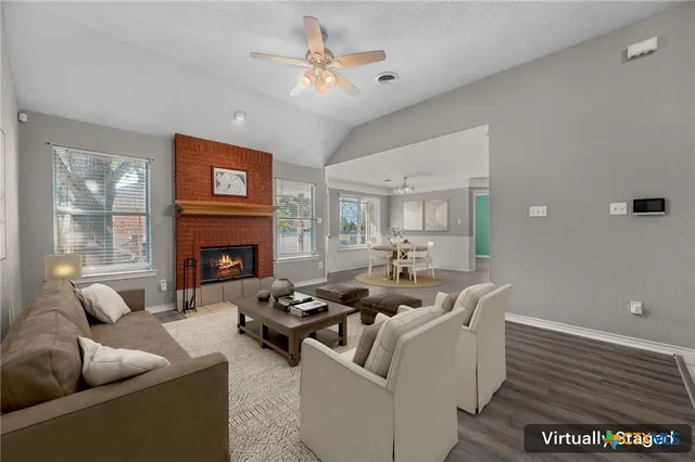 a living room with furniture and a fireplace