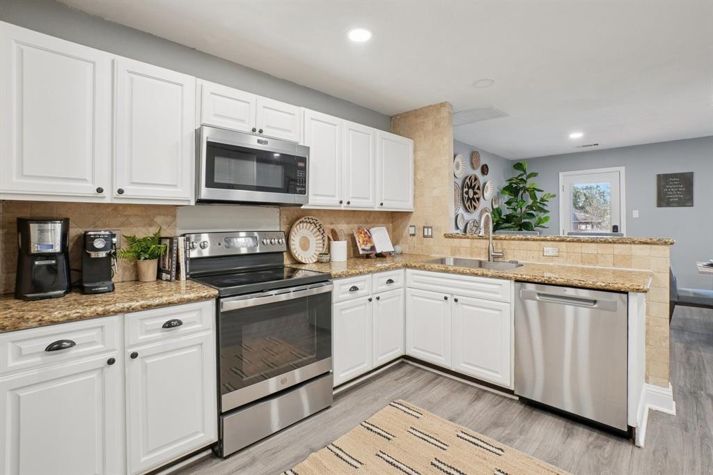 7006 Burning Bush Sachse, TX 75048 - Photo 13 of 39 a kitchen with granite countertop white cabinets white stainless steel appliances with a sink and dishwasher