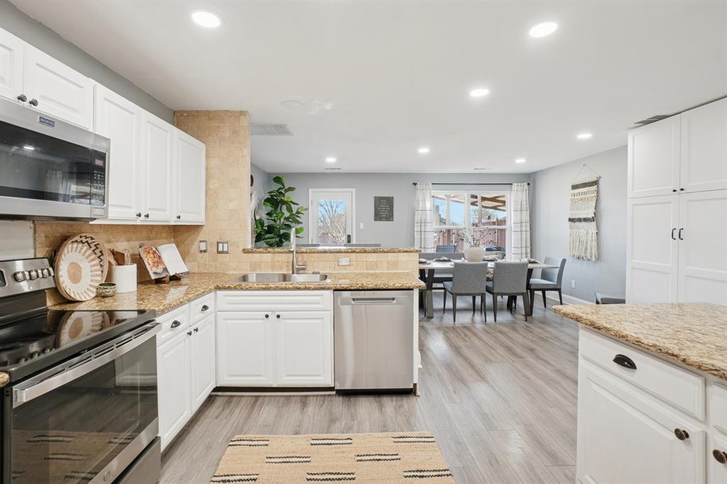 7006 Burning Bush Sachse, TX 75048 - Photo 14 of 39 a kitchen with sink stove top oven and cabinets