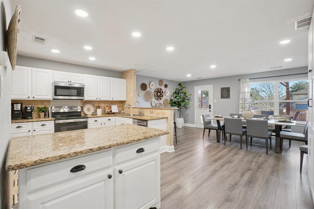 7006 Burning Bush Sachse, TX 75048 - Photo 16 of 39 a large kitchen with stainless steel appliances