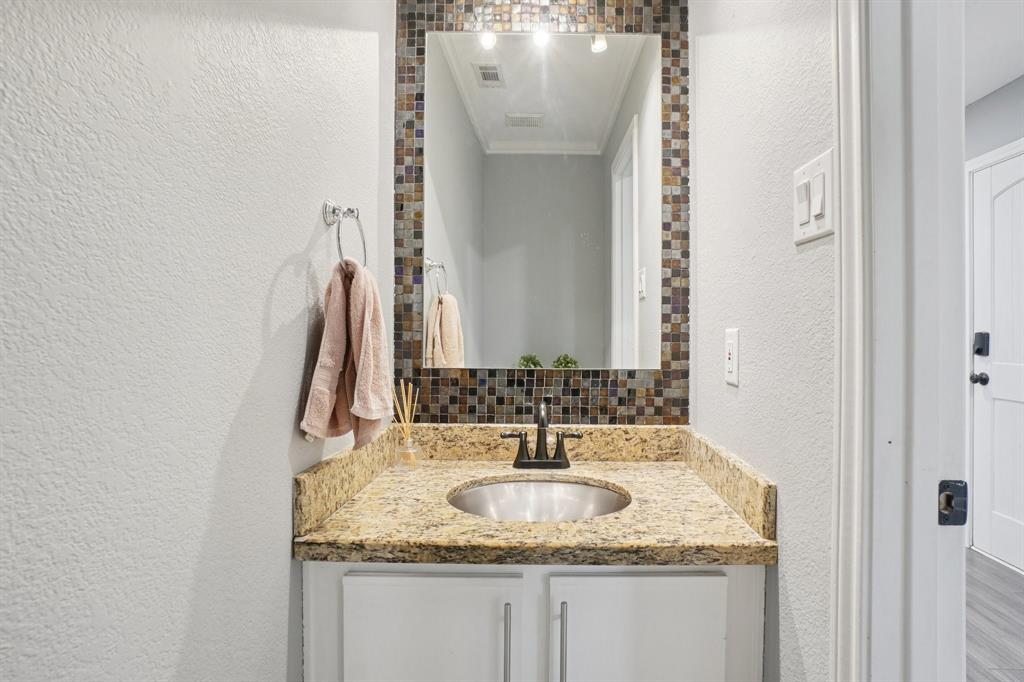 7006 Burning Bush Sachse, TX 75048 - Photo 19 of 39 a bathroom with a granite countertop sink and a mirror