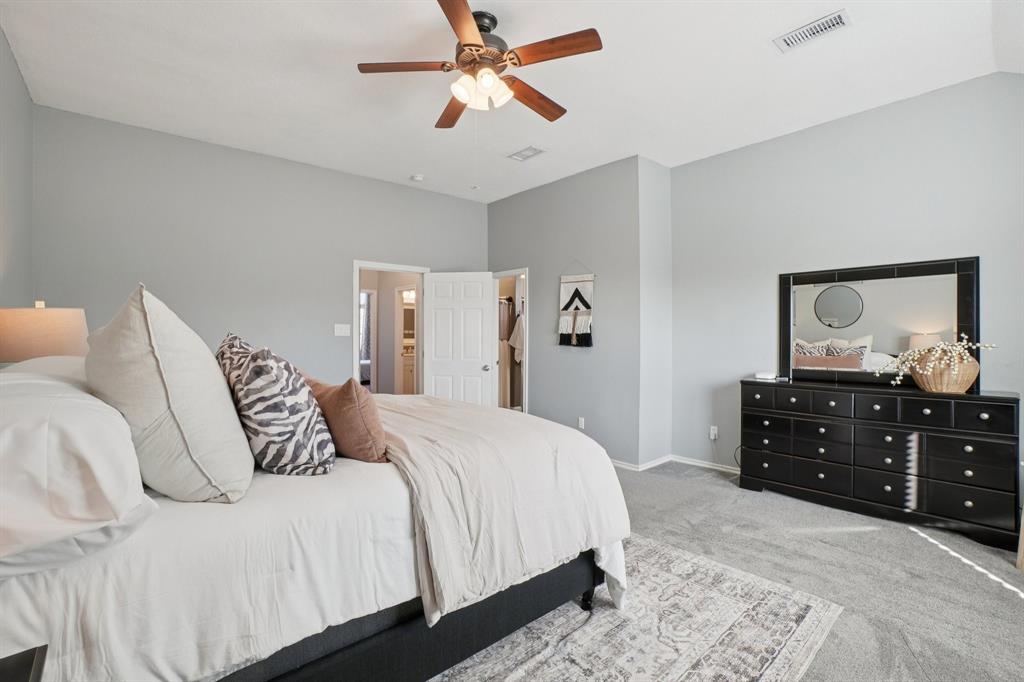 7006 Burning Bush Sachse, TX 75048 - Photo 20 of 39 a bedroom with a bed and wooden floor