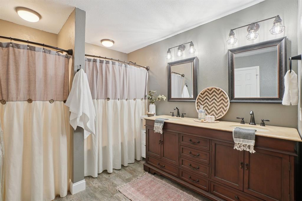 7006 Burning Bush Sachse, TX 75048 - Photo 23 of 39 a bathroom with a double vanity sink mirror and shower