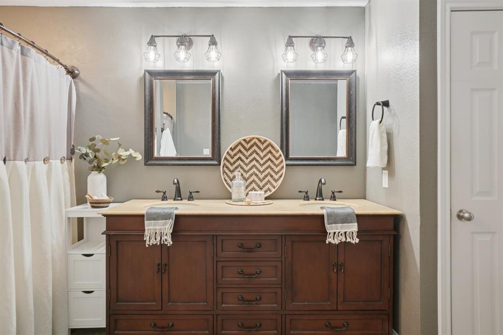 7006 Burning Bush Sachse, TX 75048 - Photo 24 of 39 a bathroom with a sink double vanity and a mirror