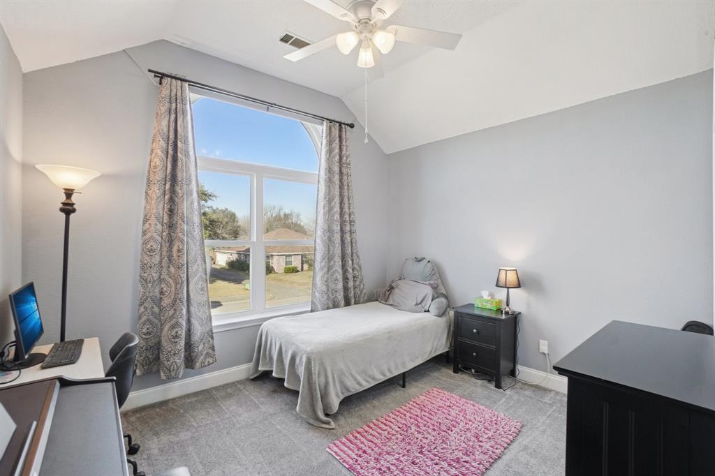 7006 Burning Bush Sachse, TX 75048 - Photo 31 of 39 a bedroom with a bed window and a table