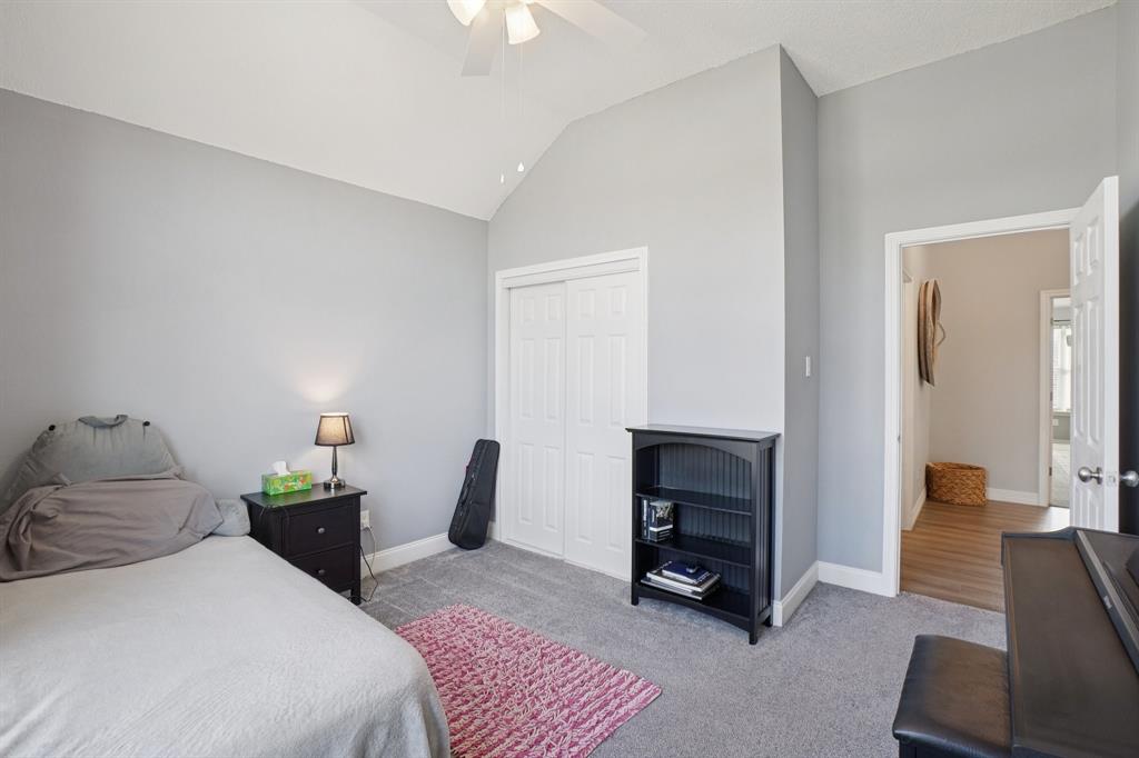 7006 Burning Bush Sachse, TX 75048 - Photo 32 of 39 a bedroom with furniture and a fireplace