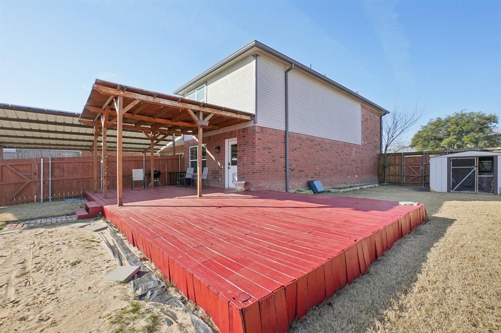 7006 Burning Bush Sachse, TX 75048 - Photo 34 of 39 a patio with a table and chairs under an umbrella