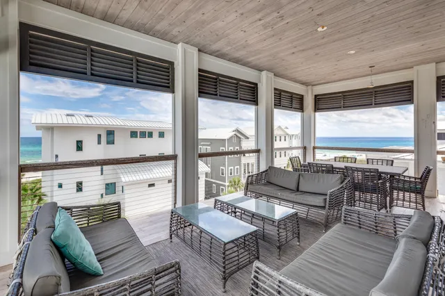 a living room with furniture a flat screen tv and a large window