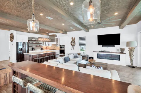 a kitchen with kitchen island a sink stove and refrigerator