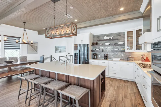 a view of a dining room with furniture and a chandelier