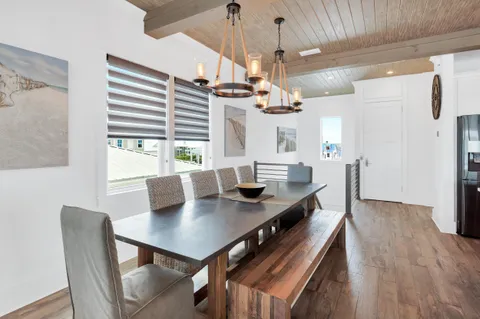 a living room with stainless steel appliances kitchen island granite countertop a sink and a large window