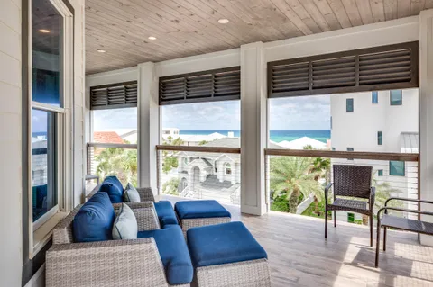 a bedroom with a bed a flat screen tv and a large window