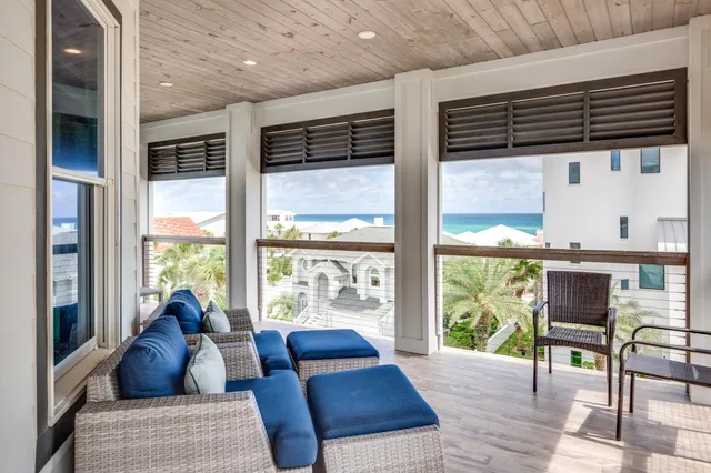 a bedroom with a bed a flat screen tv and a large window