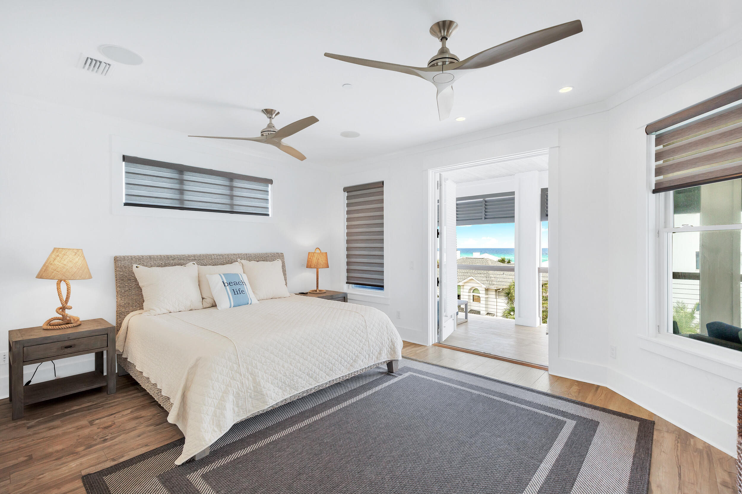 64 Emerald Cove Lane South Inlet Beach, FL 32461 - Photo 41 of 44 a bedroom with a large bed and a chandelier