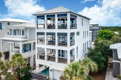 a kitchen with stainless steel appliances kitchen island granite countertop a table and chairs in it