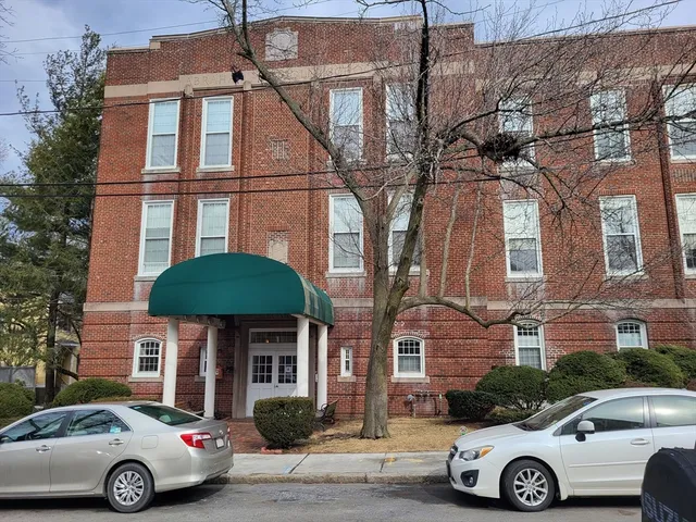 a front view of a house with parking space