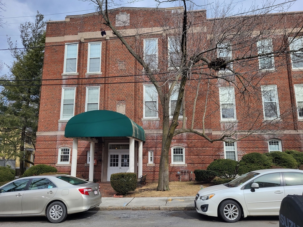 a front view of a house with parking space