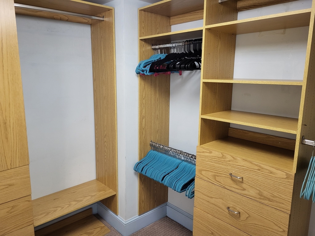 35 Walden Street, Unit 3B Cambridge, MA 02140 - Photo 13 of 39 a view of walk in closet with clothes and shoes