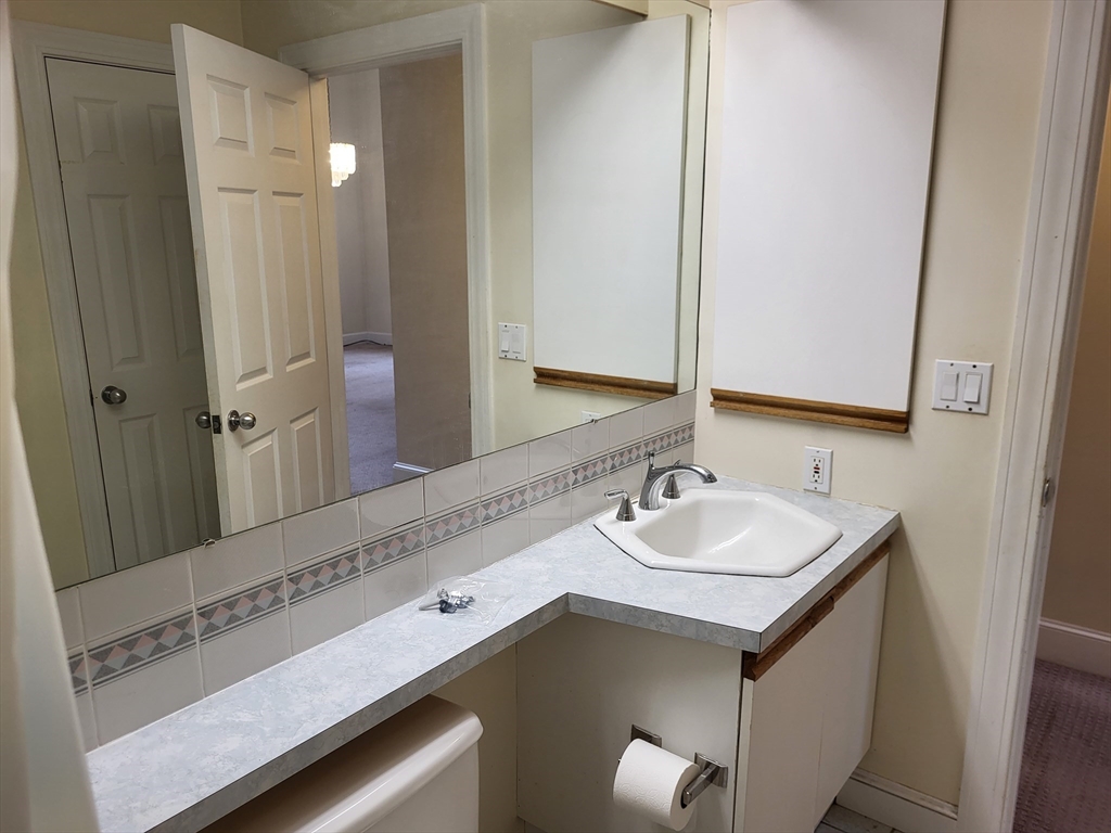 35 Walden Street, Unit 3B Cambridge, MA 02140 - Photo 19 of 39 a bathroom with a sink and a mirror