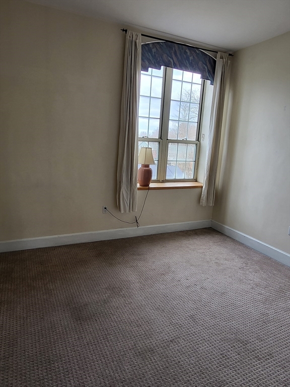 35 Walden Street, Unit 3B Cambridge, MA 02140 - Photo 4 of 39 an empty room with wooden floor and windows