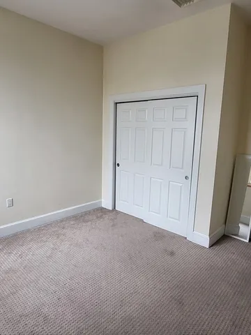 a view of an empty room and entryway