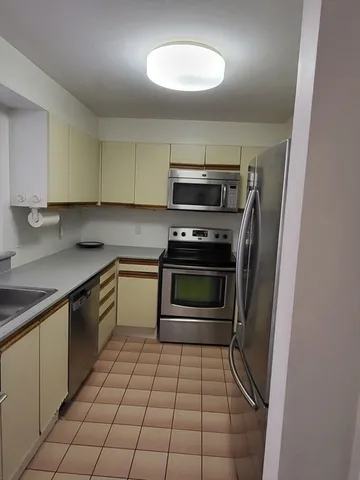 a kitchen with a stove a sink and a microwave