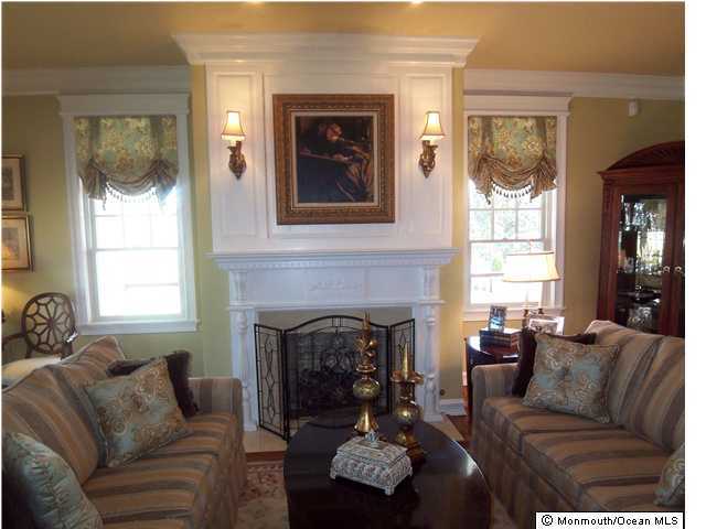 205 Tuttle Avenue Spring Lake, NJ 07762 - Photo 3 of 3 a living room with furniture and a fireplace