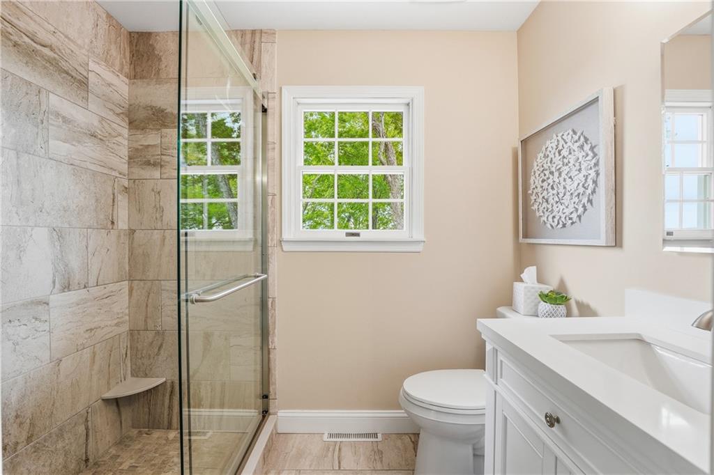 267 Forsythe Road Mars, PA 16046 - Photo 24 of 41 a bathroom with a granite countertop toilet a sink and a shower