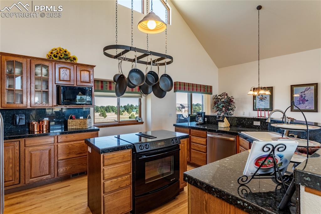 18165 Pinon Park Road Peyton, CO 80831 - Photo 11 of 44 a kitchen with stainless steel appliances granite countertop a stove and a sink
