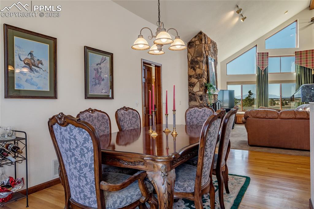 18165 Pinon Park Road Peyton, CO 80831 - Photo 13 of 44 a view of a dining room with furniture and wooden floor