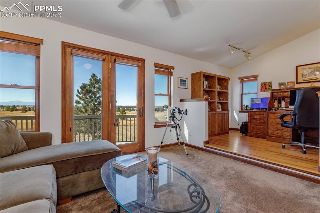 18165 Pinon Park Road Peyton, CO 80831 - Photo 15 of 44 a living room with furniture a flat screen tv and a large window