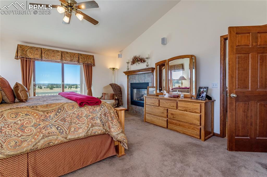 18165 Pinon Park Road Peyton, CO 80831 - Photo 17 of 44 a bedroom with a bed and a chandelier