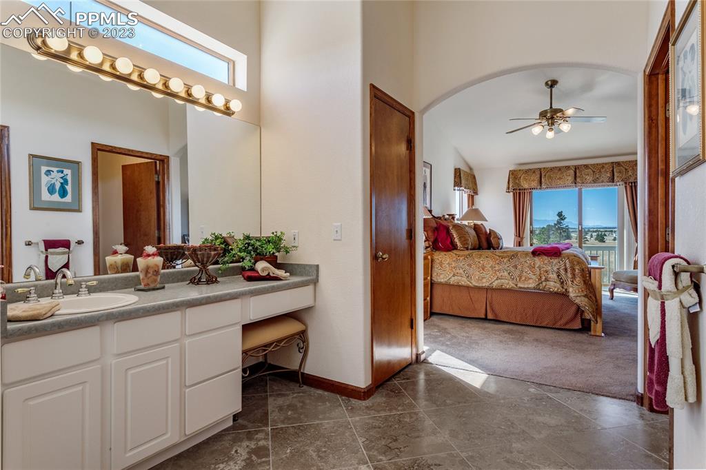 18165 Pinon Park Road Peyton, CO 80831 - Photo 20 of 44 a en suite bathroom with a double vanity sink and a mirror