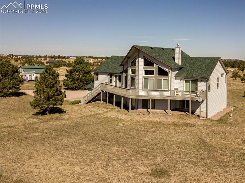 18165 Pinon Park Road Peyton, CO 80831 - Photo 2 of 44 a view of a house with roof deck