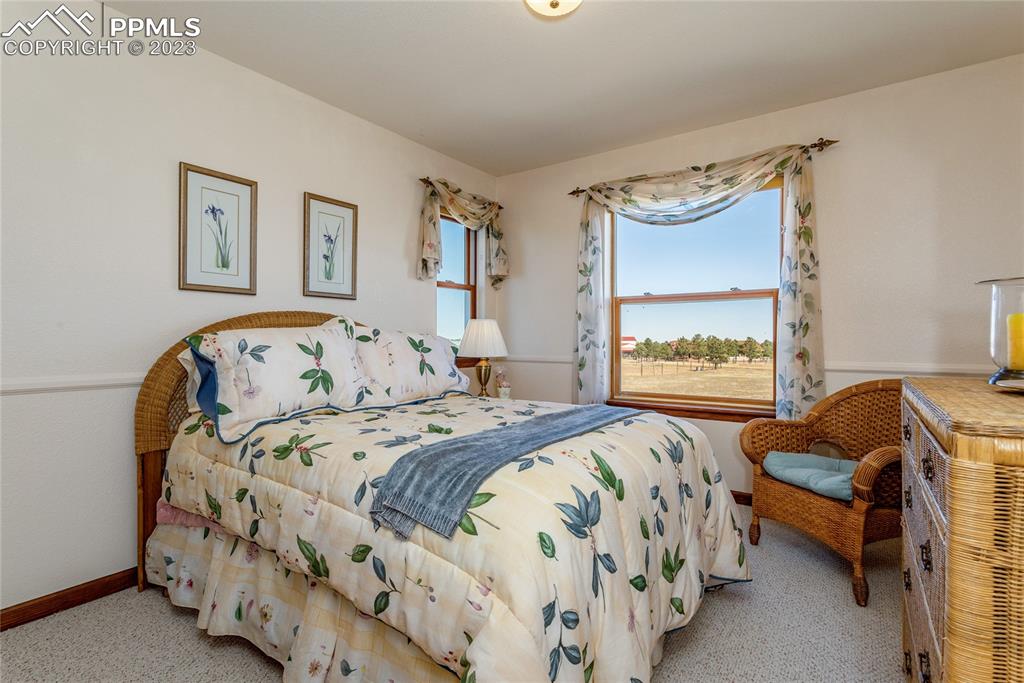 18165 Pinon Park Road Peyton, CO 80831 - Photo 23 of 44 a bedroom with a bed and a couch