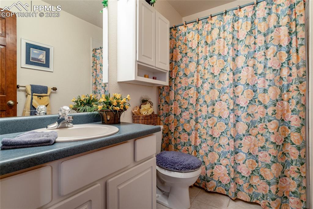 18165 Pinon Park Road Peyton, CO 80831 - Photo 25 of 44 a bathroom with a sink and a mirror