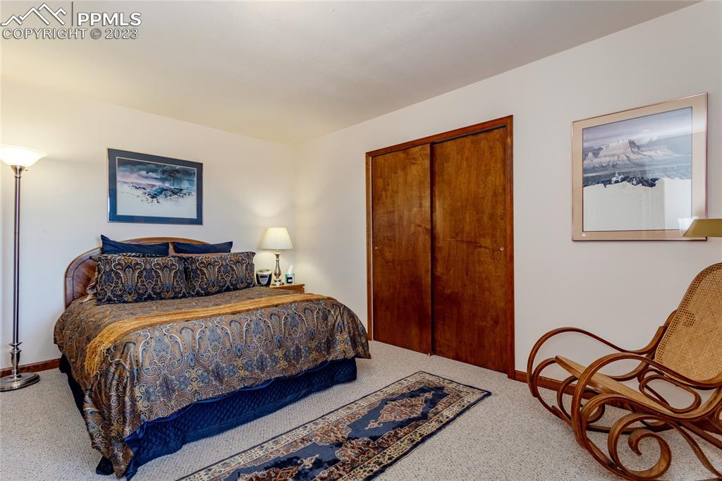 18165 Pinon Park Road Peyton, CO 80831 - Photo 29 of 44 a bedroom with a bed and a painting on the wall