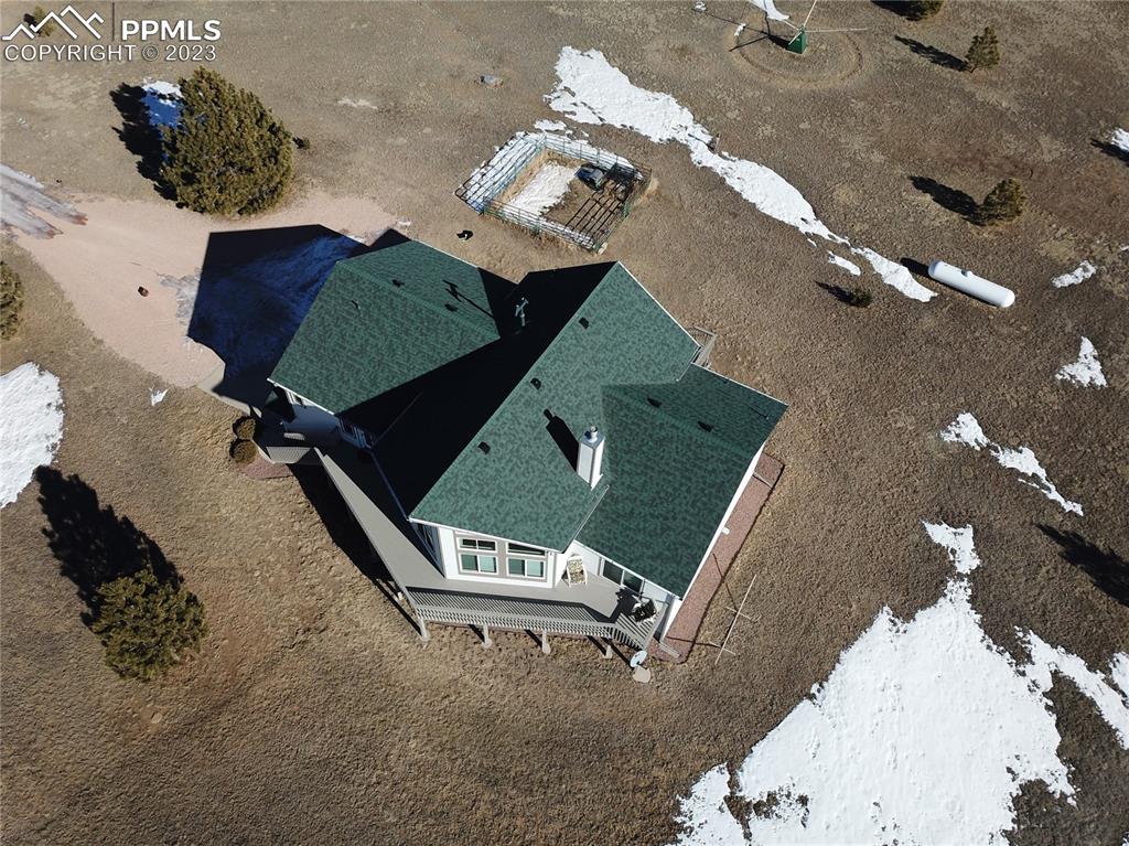 18165 Pinon Park Road Peyton, CO 80831 - Photo 37 of 44 an aerial view of a backyard with table and chairs