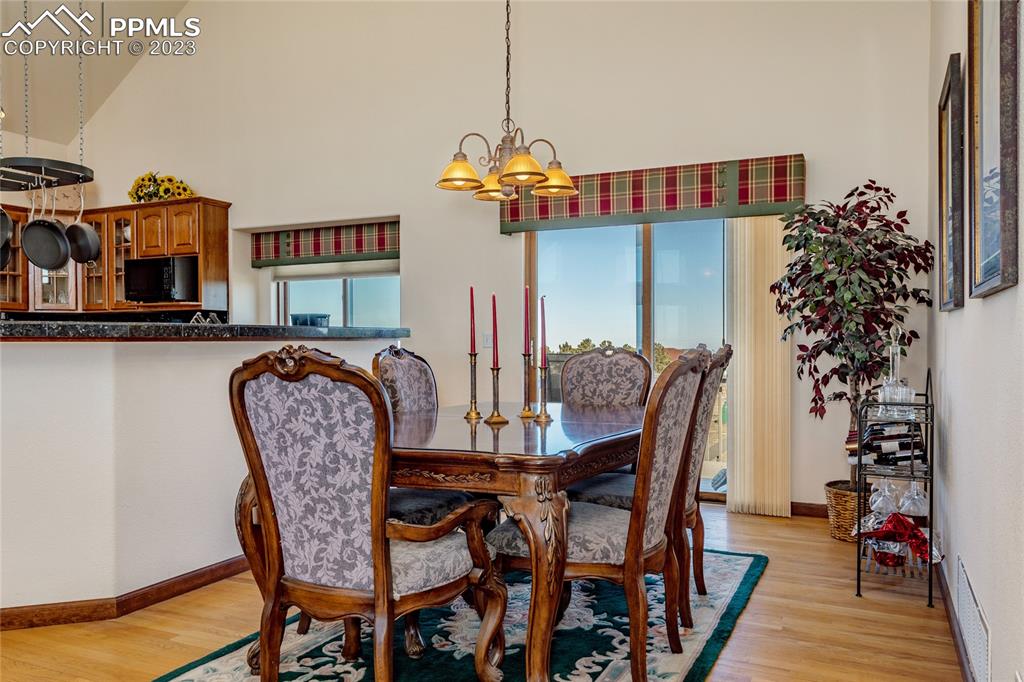 18165 Pinon Park Road Peyton, CO 80831 - Photo 8 of 44 a dining room with furniture and wooden floor