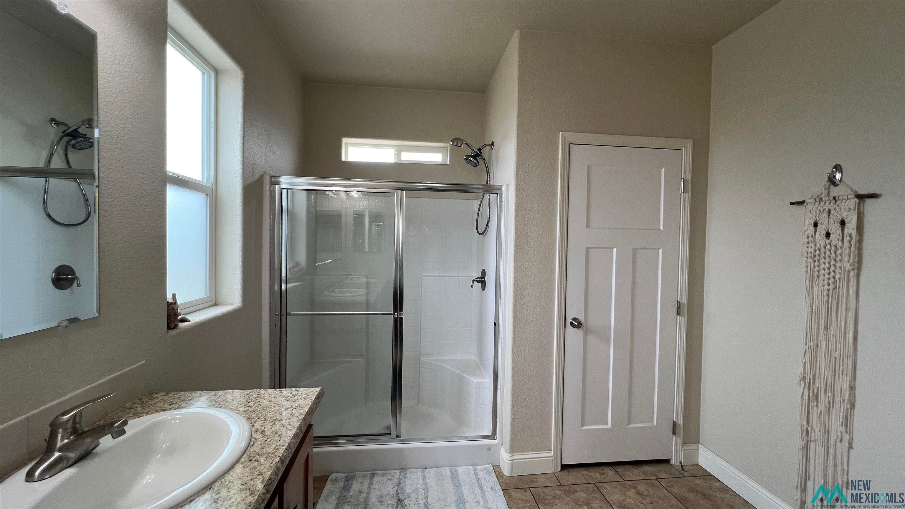 56 Kachina Road Quemado, NM 87829 - Photo 15 of 36 Full bathroom featuring vanity, a shower stall, and light tile patterned floors