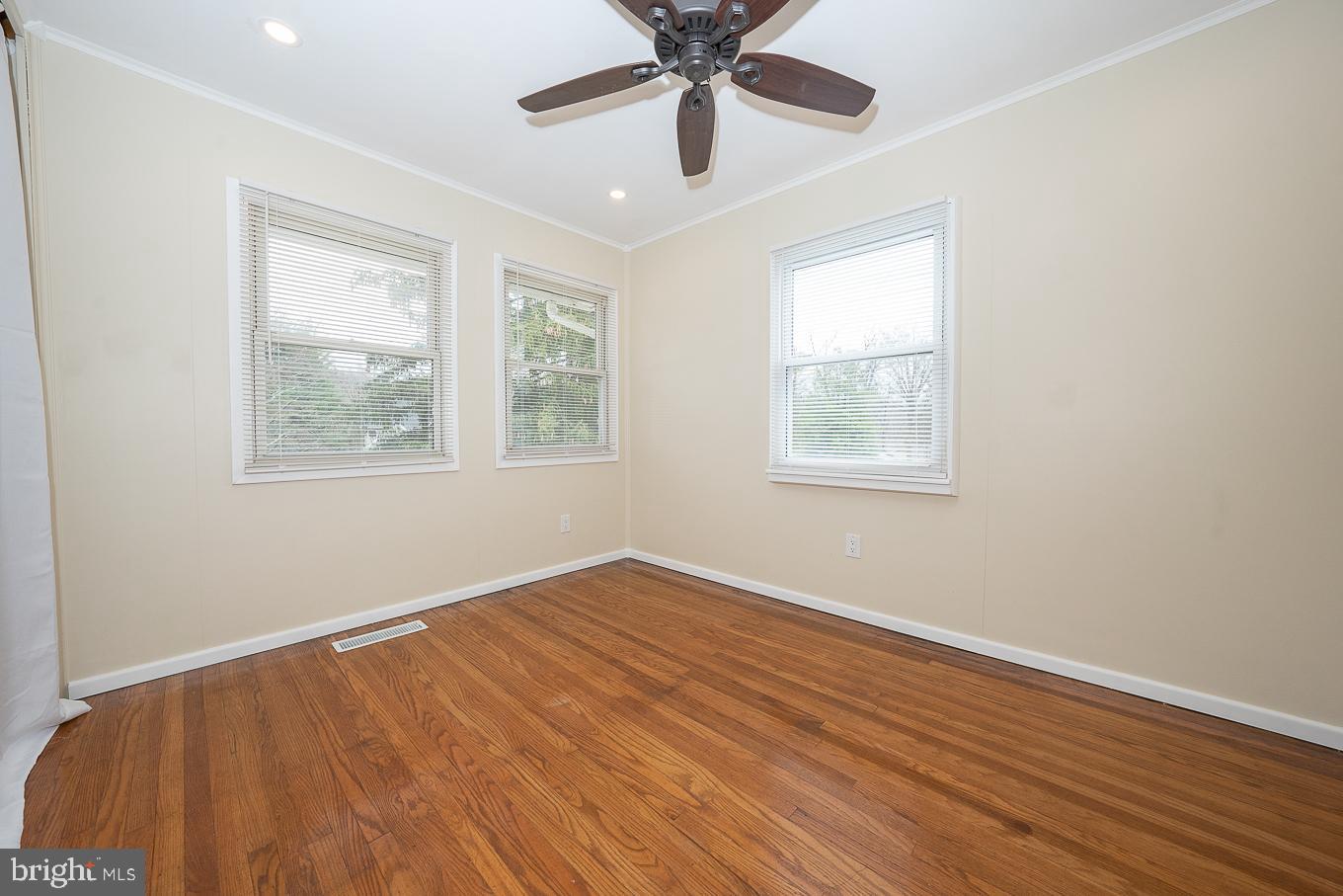 437 Meadowcroft Road Wayne, PA 19087 - Photo 11 of 19 a view of an empty room with wooden floor and a window