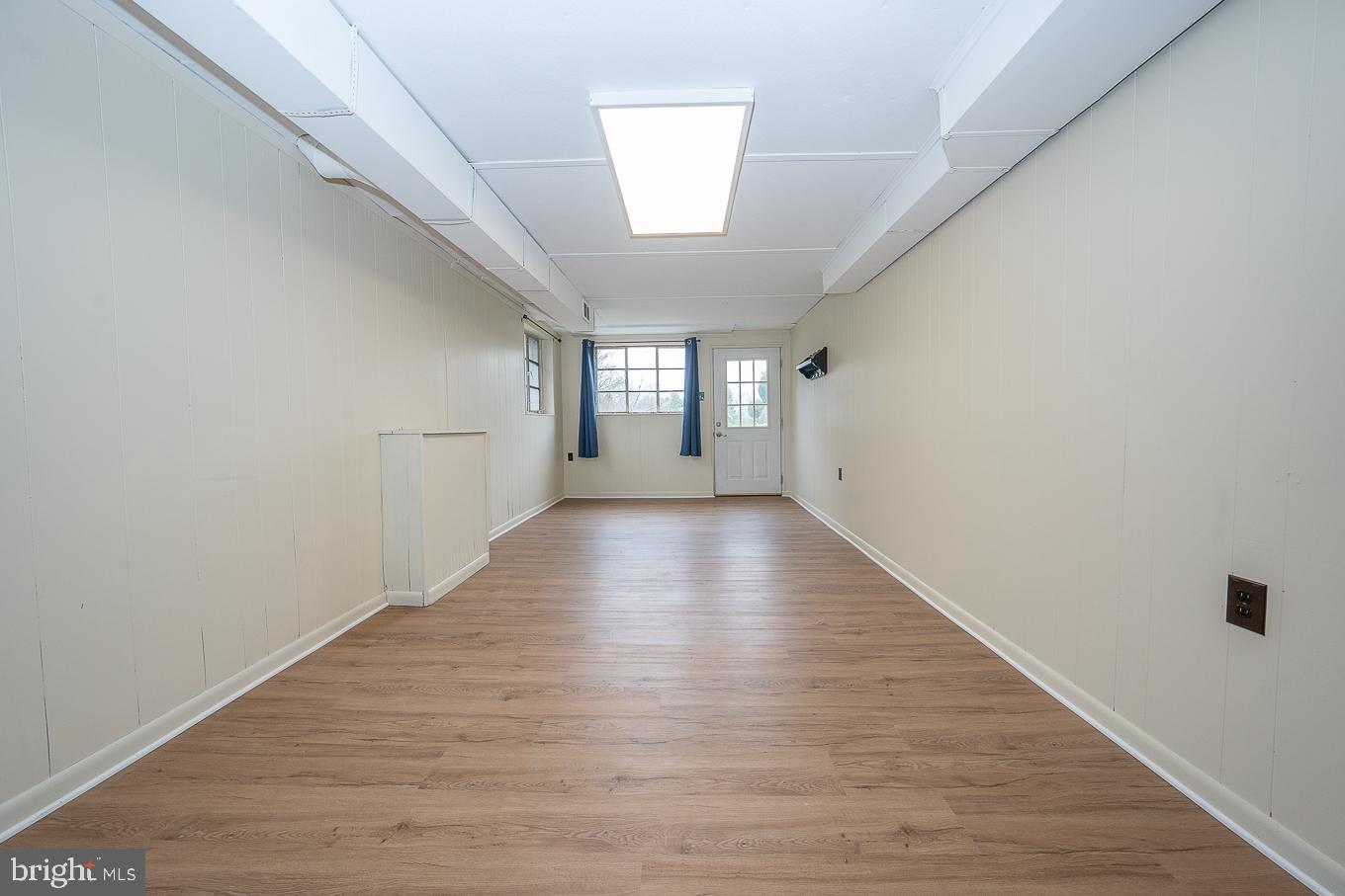 437 Meadowcroft Road Wayne, PA 19087 - Photo 14 of 19 a view of an empty room with wooden floor and a window