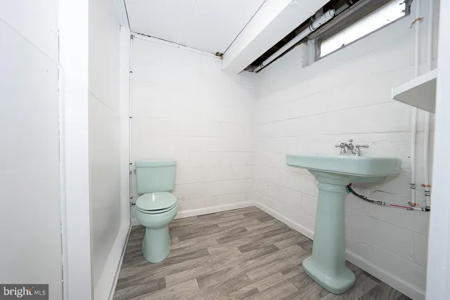 a bathroom with a toilet sink and vanity