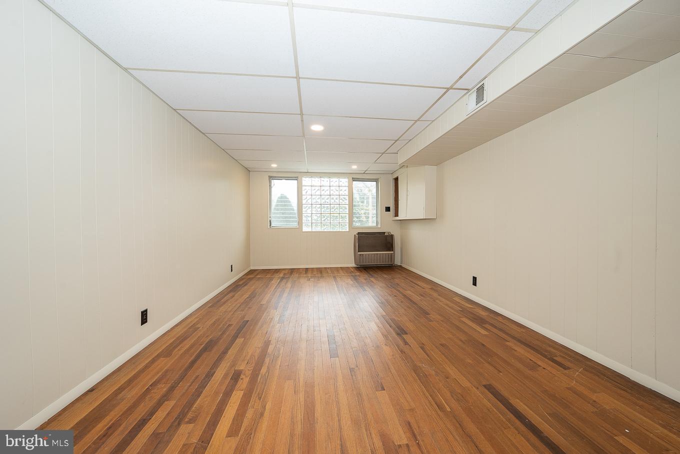 437 Meadowcroft Road Wayne, PA 19087 - Photo 16 of 19 an empty room with wooden floor and windows