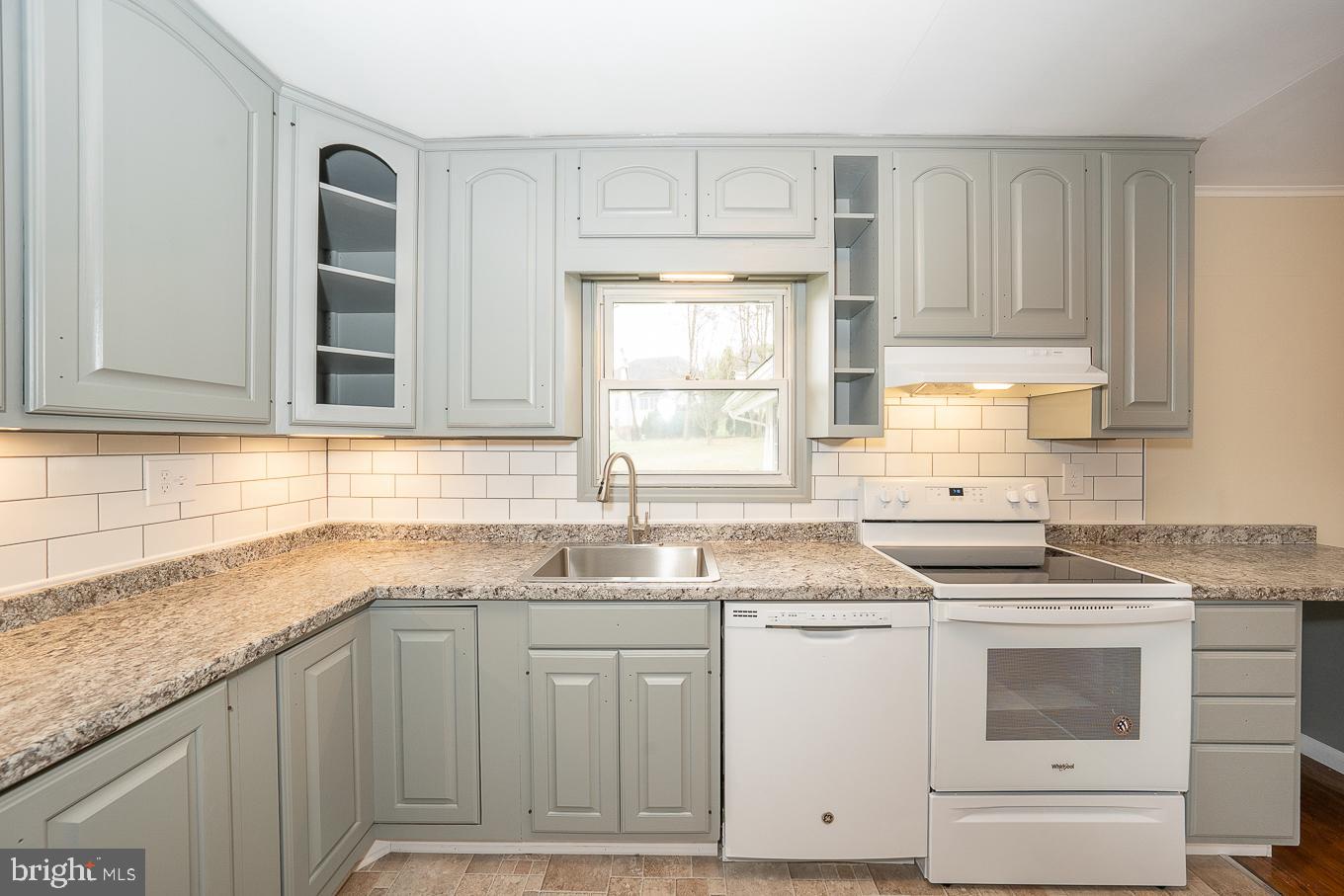 437 Meadowcroft Road Wayne, PA 19087 - Photo 6 of 19 a kitchen with granite countertop a sink stainless steel appliances and cabinets