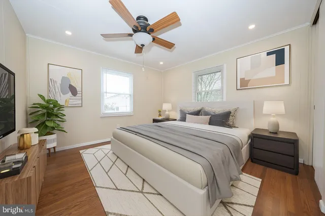 a bedroom with bed and a potted plant