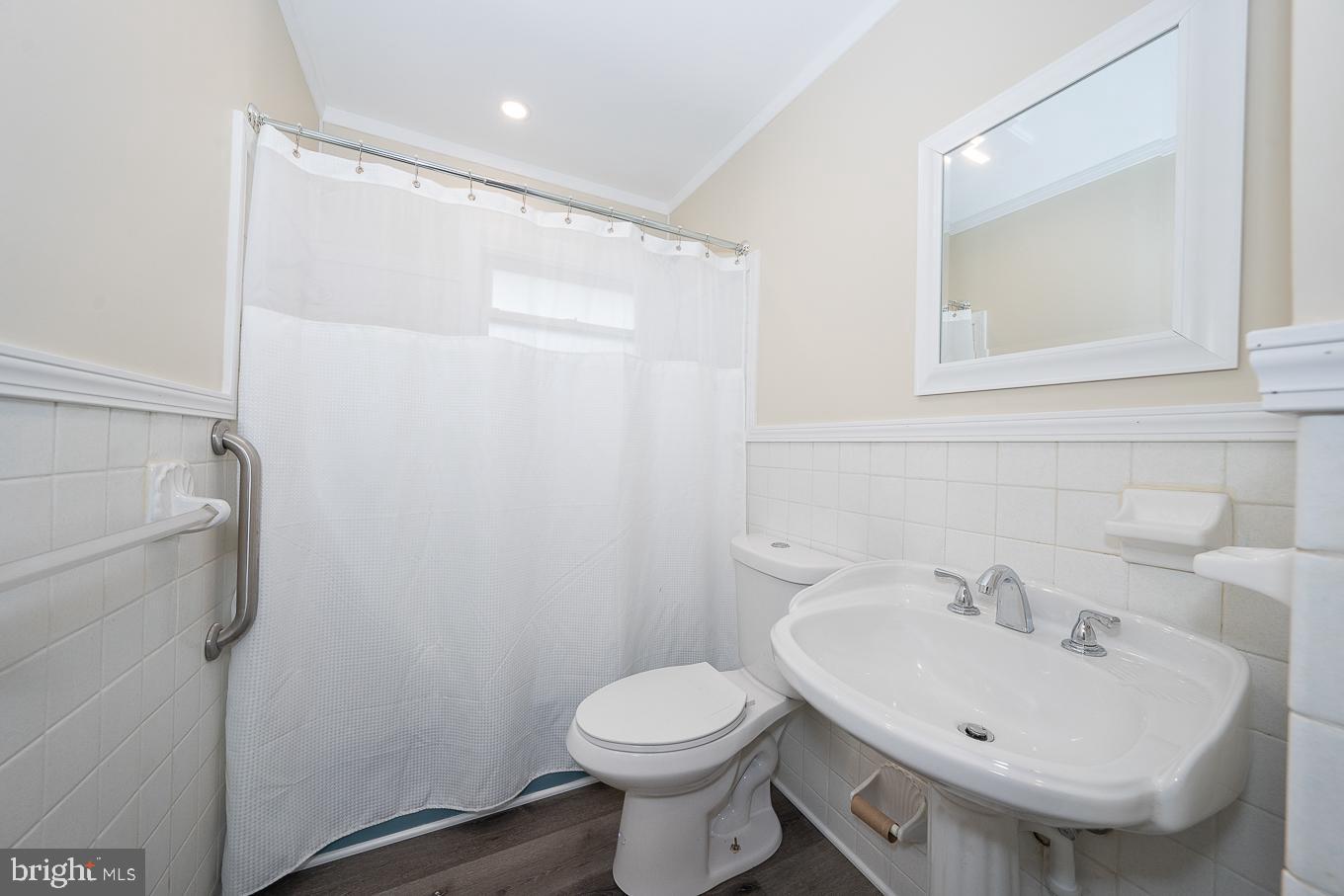 437 Meadowcroft Road Wayne, PA 19087 - Photo 10 of 19 a bathroom with a sink toilet and a mirror