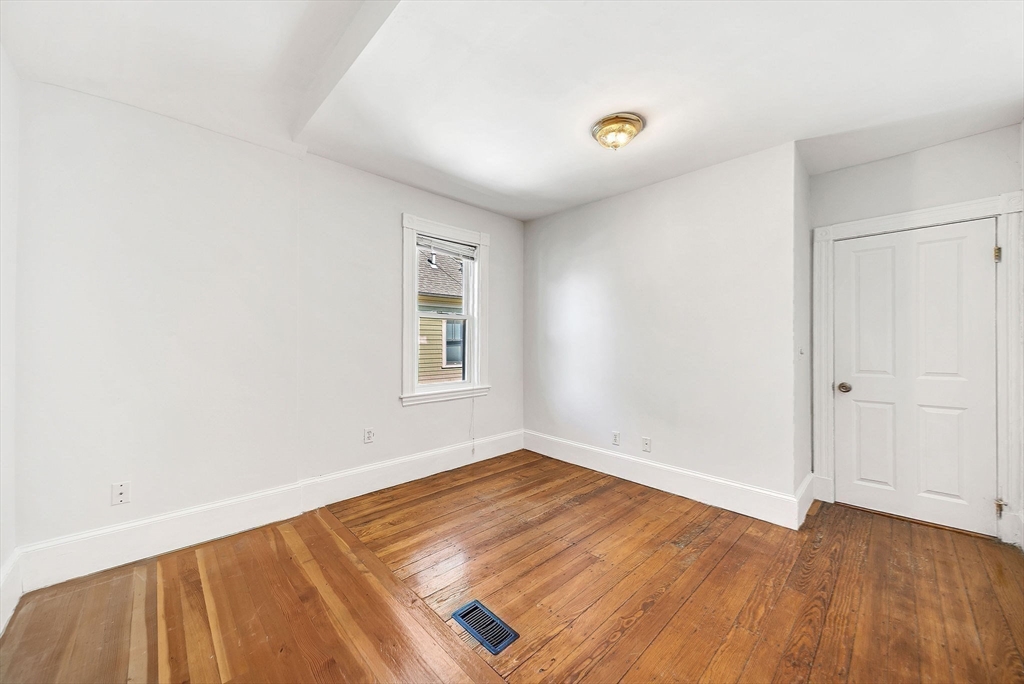 13 Weir Street Newton, MA 02466 - Photo 21 of 41 an empty room with wooden floor and windows